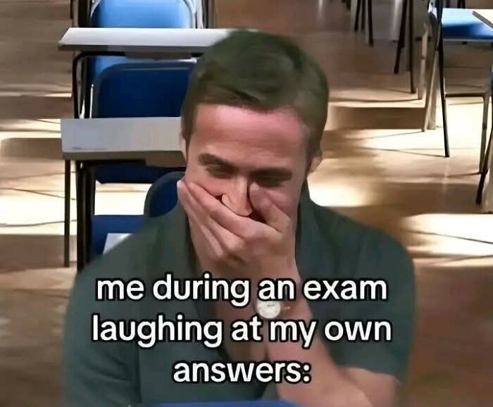 Man in classroom covering mouth laughing at own exam answers, humorous educational meme on studying and tests.