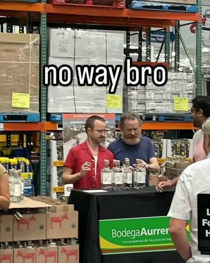 Two men at a spirits tasting table in a warehouse store with text overlay no way bro in popular pics that go hard