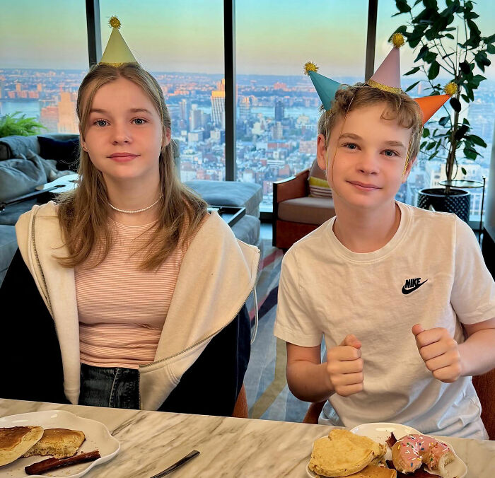 Teen girl with subtle makeup and long hair wearing a party hat, showcasing a grown-up look at a city view location. Teen girl with subtle makeup and long hair wearing a party hat, showcasing a grown-up look at a city view location.