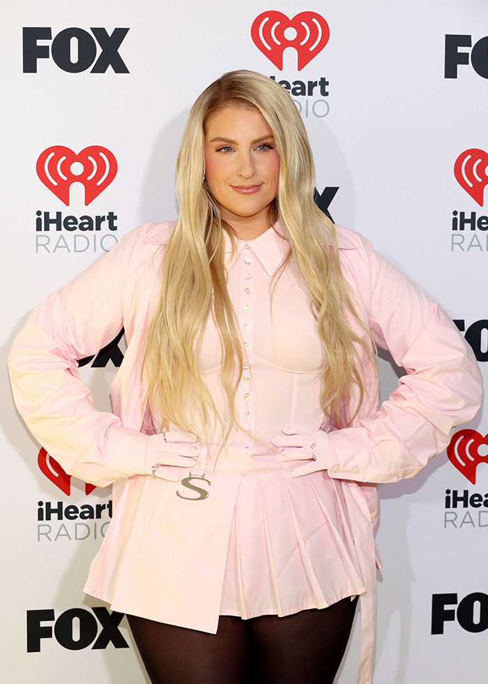 Meghan Trainor wearing a light pink outfit with long blonde hair at an iHeartRadio and FOX event. Meghan Trainor wearing a light pink outfit with long blonde hair at an iHeartRadio and FOX event.