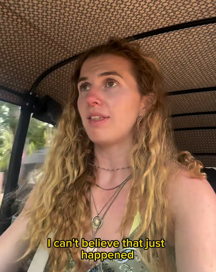 Woman with long curly hair revealing disturbing truth about solo traveling, looking concerned inside a vehicle. Woman with long curly hair revealing disturbing truth about solo traveling, looking concerned inside a vehicle.