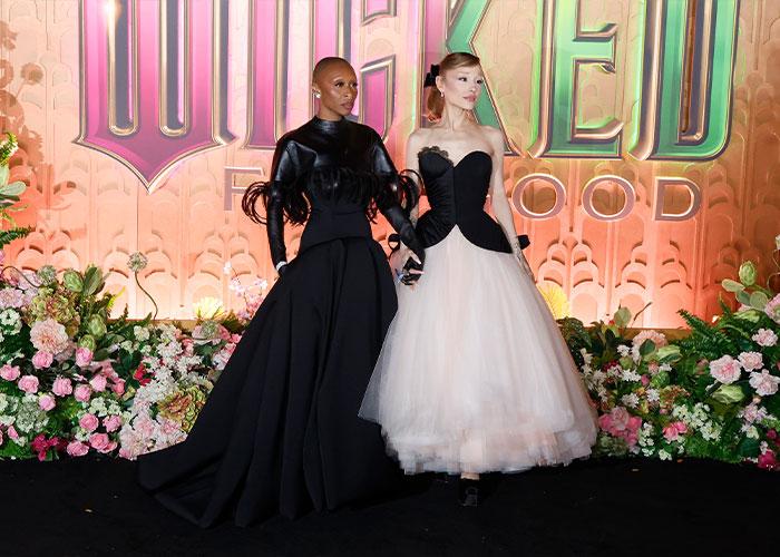 Ariana Grande and Cynthia Erivo posing together at an event, dressed in elegant black and white gowns. Ariana Grande and Cynthia Erivo posing together at an event, dressed in elegant black and white gowns.