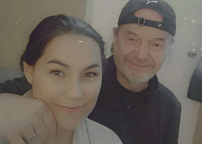Mother and husband posing together indoors, capturing a somber and intimate family moment. Mother and husband posing together indoors, capturing a somber and intimate family moment.