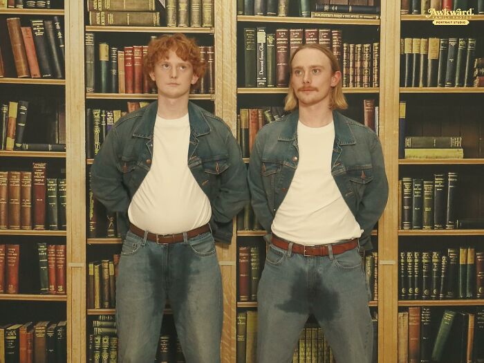 Two men in matching denim outfits posing awkwardly in front of a bookshelf in awkward studio pics with humorous expressions.