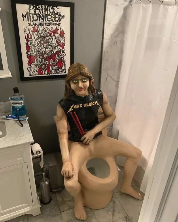 Unusual bathroom decor featuring a life-size figure seated on a toilet in a unique Zillow homes listing.