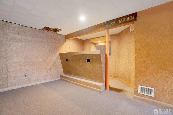 Unusual interior of a Zillow home with a worm garden sign, showcasing one of the unique Zillow homes to see and believe.