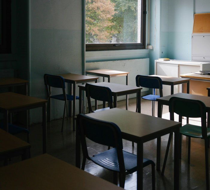 Empty classroom with desks and chairs, illustrating a quiet setting for family drama shared online stories.