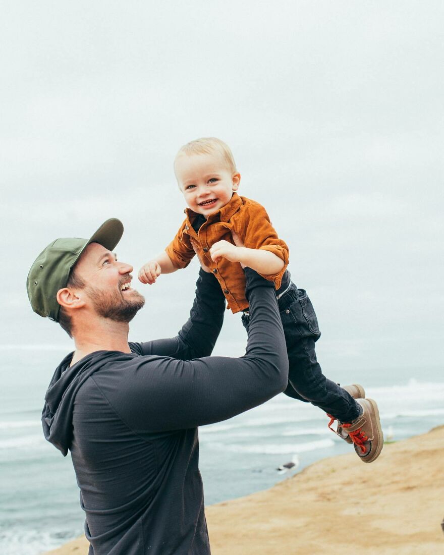 Stevin John wearing a cap lifting a smiling child by the ocean, illustrating the warmth behind how many Blippis actors have worn the bow tie. Stevin John wearing a cap lifting a smiling child by the ocean, illustrating the warmth behind how many Blippis actors have worn the bow tie.