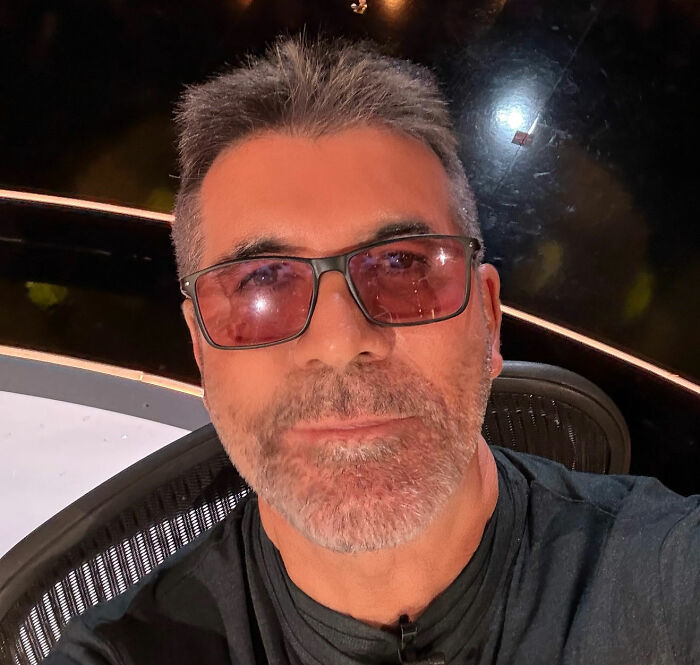 Simon Cowell wearing tinted glasses and a black shirt, addressing claims about Liam Payne's mental collapse in a close-up selfie. Simon Cowell wearing tinted glasses and a black shirt, addressing claims about Liam Payne's mental collapse in a close-up selfie.