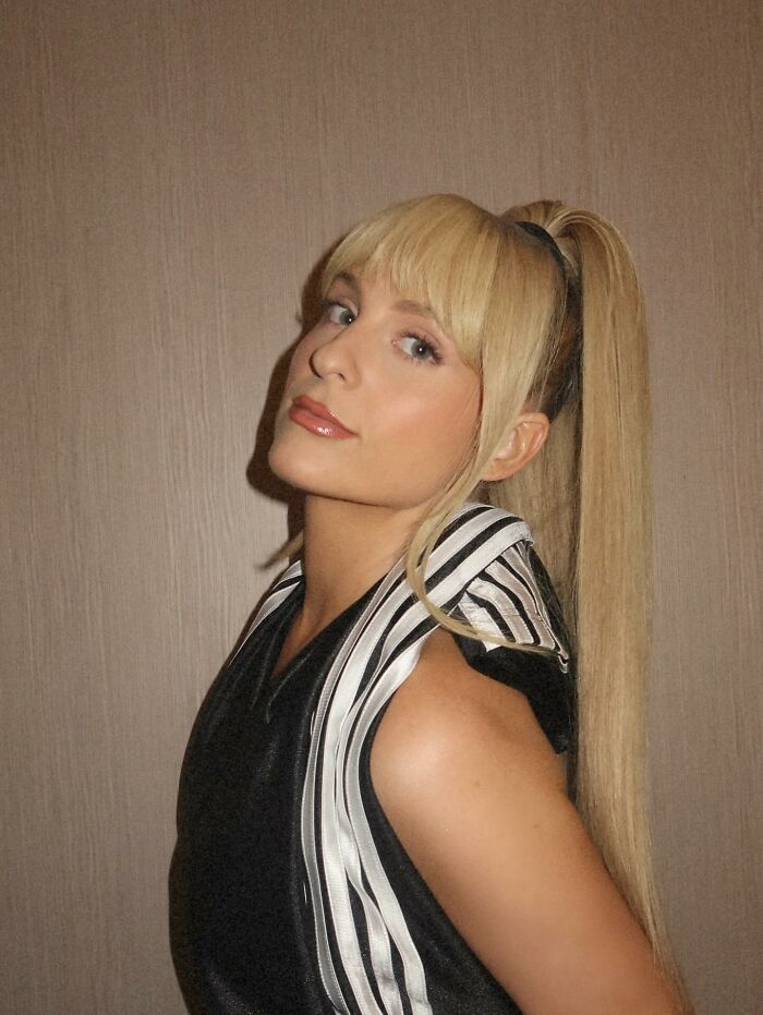 Meghan Trainor with long blonde ponytail and fringe, showcasing her new look that sparked hilarious fan reactions. Meghan Trainor with long blonde ponytail and fringe, showcasing her new look that sparked hilarious fan reactions.