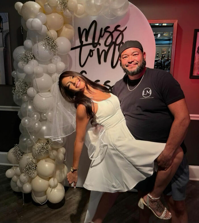 Couple posing happily at a party with white balloon arch, relating to Jon Gosselin remarries and wedding vows topics. Couple posing happily at a party with white balloon arch, relating to Jon Gosselin remarries and wedding vows topics.