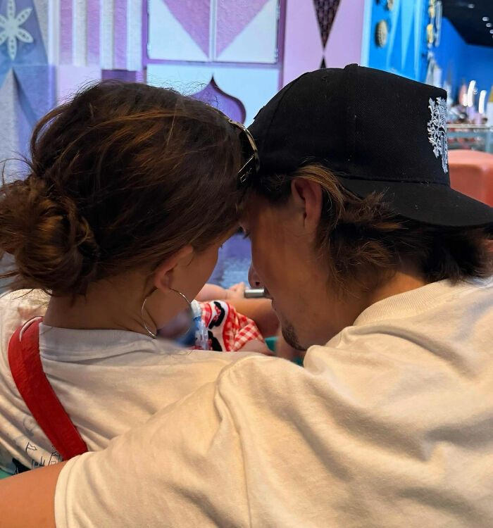 Millie Bobby Brown with a man in a casual setting, showing close interaction and casual attire indoors. Millie Bobby Brown with a man in a casual setting, showing close interaction and casual attire indoors.