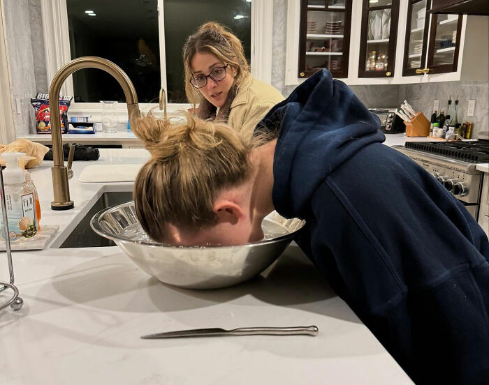 Two women in a kitchen, one with face in a bowl of water, illustrating leaked PR emails about damage control after Christy tanks. Two women in a kitchen, one with face in a bowl of water, illustrating leaked PR emails about damage control after Christy tanks.