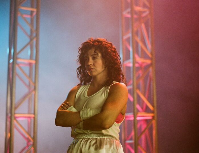 Sydney Sweeney on set with stage lighting, representing leaked PR emails and damage control after Christy box office disappointment. Sydney Sweeney on set with stage lighting, representing leaked PR emails and damage control after Christy box office disappointment.