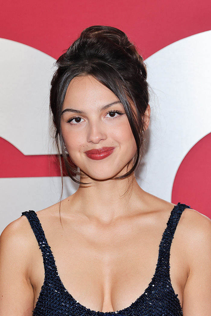Young woman with elegant updo and red lipstick wearing a dark blue dress, representing beautiful celebrities and golden ratio standards. Young woman with elegant updo and red lipstick wearing a dark blue dress, representing beautiful celebrities and golden ratio standards.