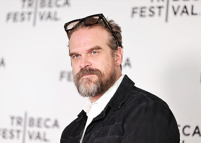 David Harbour at Tribeca Festival, wearing a black jacket and glasses on head, linked to Stranger Things co-star love admission. David Harbour at Tribeca Festival, wearing a black jacket and glasses on head, linked to Stranger Things co-star love admission.
