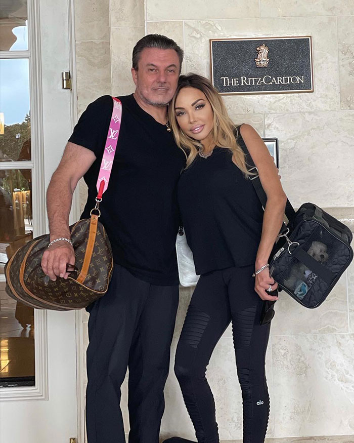 Man and woman standing outside The Ritz Carlton, highlighting fake plastic surgeon involved in botched silicone injections case. Man and woman standing outside The Ritz Carlton, highlighting fake plastic surgeon involved in botched silicone injections case.