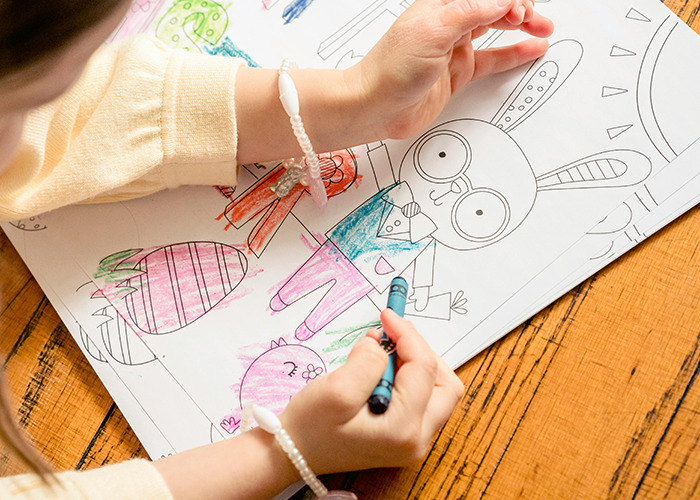 Child coloring a cartoon rabbit with crayons, illustrating a story about horrible gifts people have actually received.