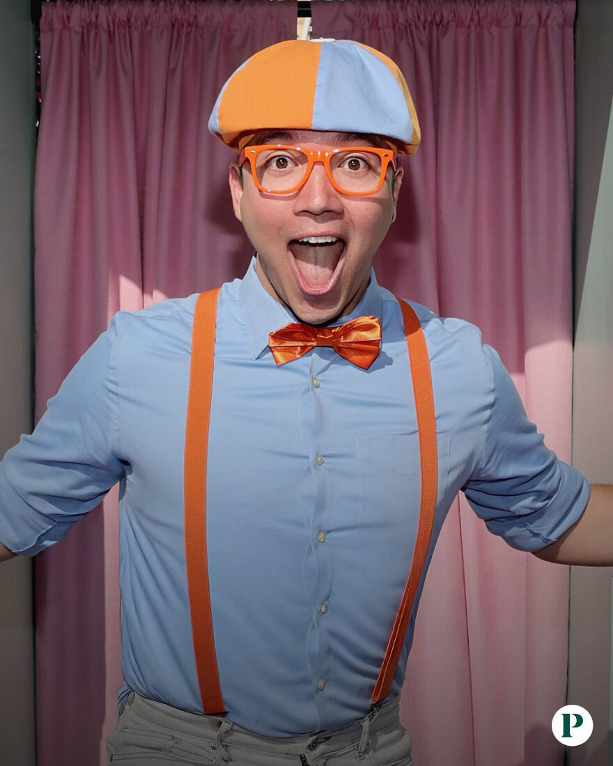Actor Clayton Grimm dressed as Blippi wearing orange bow tie, suspenders, and hat, smiling enthusiastically in front of pink curtains. Actor Clayton Grimm dressed as Blippi wearing orange bow tie, suspenders, and hat, smiling enthusiastically in front of pink curtains.