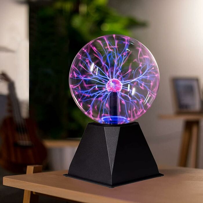 Plasma ball novelty find with colorful electric streams glowing on a black base, perfect for unique home decor.