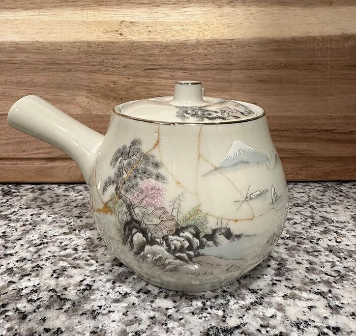 Ceramic teapot with hand-painted landscape design, a creative hobby perfect for hibernation season to keep your hands busy.