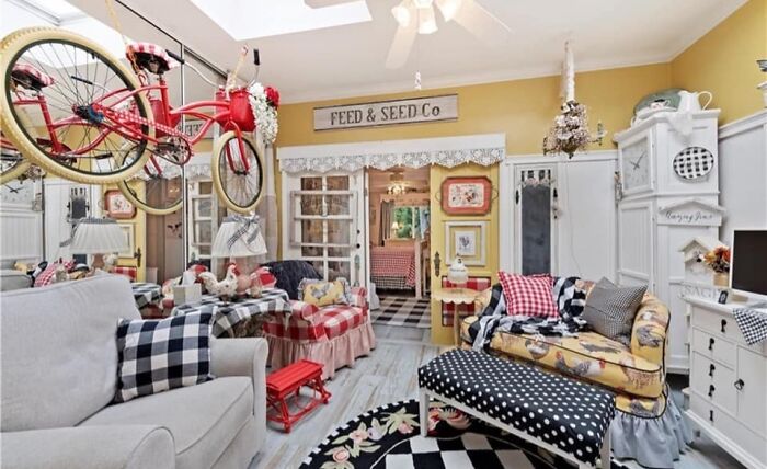 Colorful eclectic living room with vintage decor and unique bicycle display in an eye-catching Zillow homes interior.
