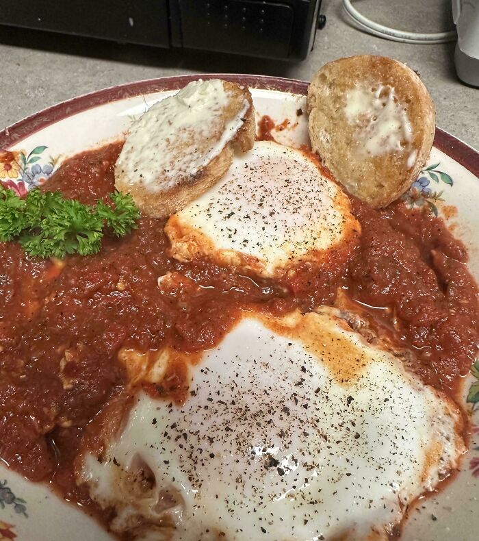 Plate of eggs cooked in tomato sauce with toasted bread, a meal causing infuriation among family members shared online