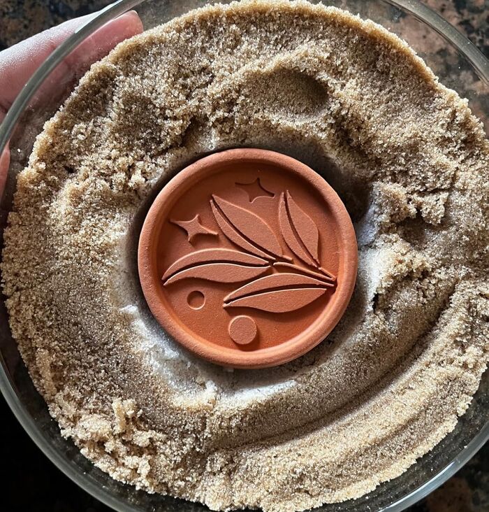 Terracotta moisture absorber placed in a bowl of brown sugar, one of the new kitchen finds trending now.