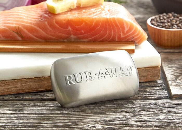 Stainless steel scrubber bar next to fresh salmon on cutting boards, featured among new kitchen finds trending now.