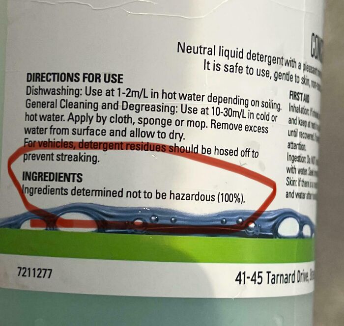 Close-up of detergent packaging showing misleading ingredient claims with a red circle highlighting the text on the label.