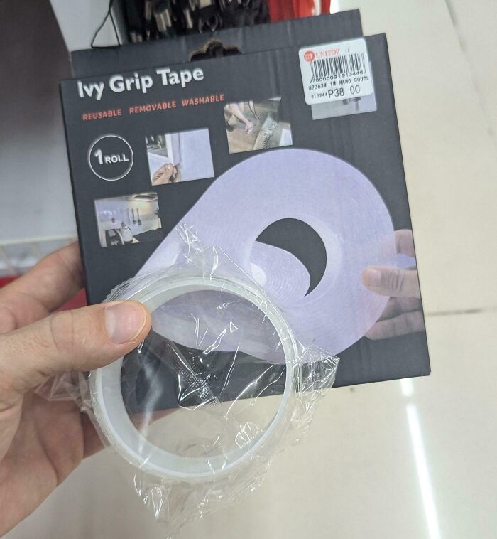 Hand holding small roll of grip tape in misleading packaging claiming one roll but containing much less tape.