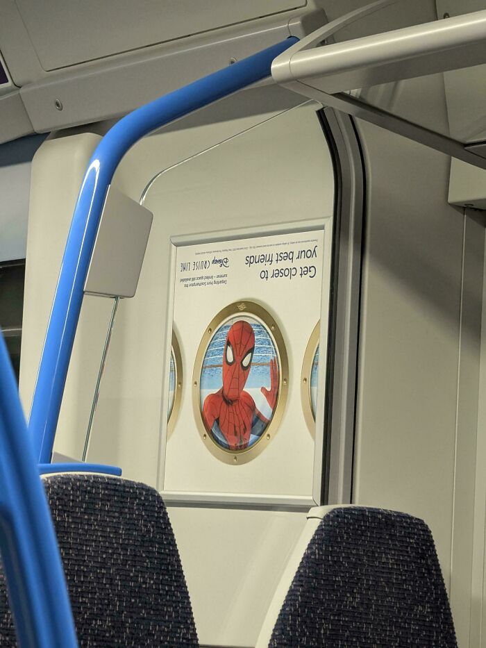 Upside-down Spiderman poster inside a public bus, showing a funny example of people not even trying at their job.