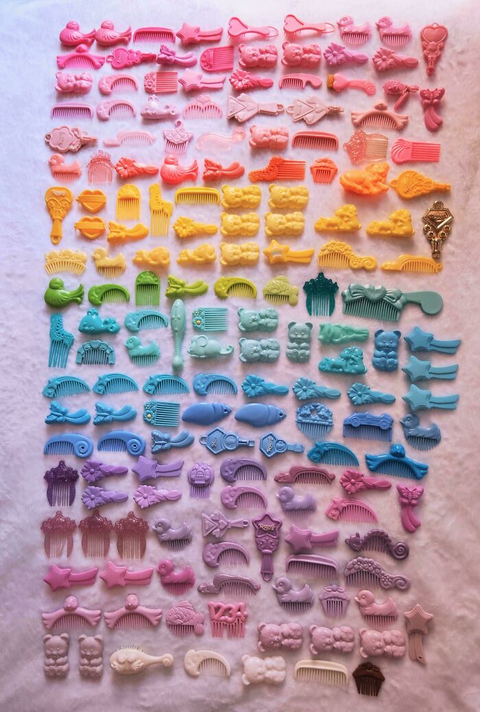 Colorful knolled vintage combs and hair accessories arranged by shape and hue on a soft background for visual order.