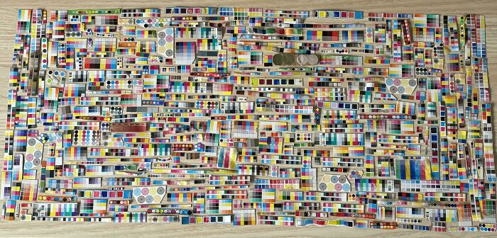 Colorful art installation of neatly arranged swatches and tiles creating a visually satisfying display of order and pattern.