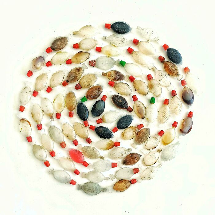 Knolled arrangement of small sauce bottles in a spiral pattern showcasing order and symmetry.