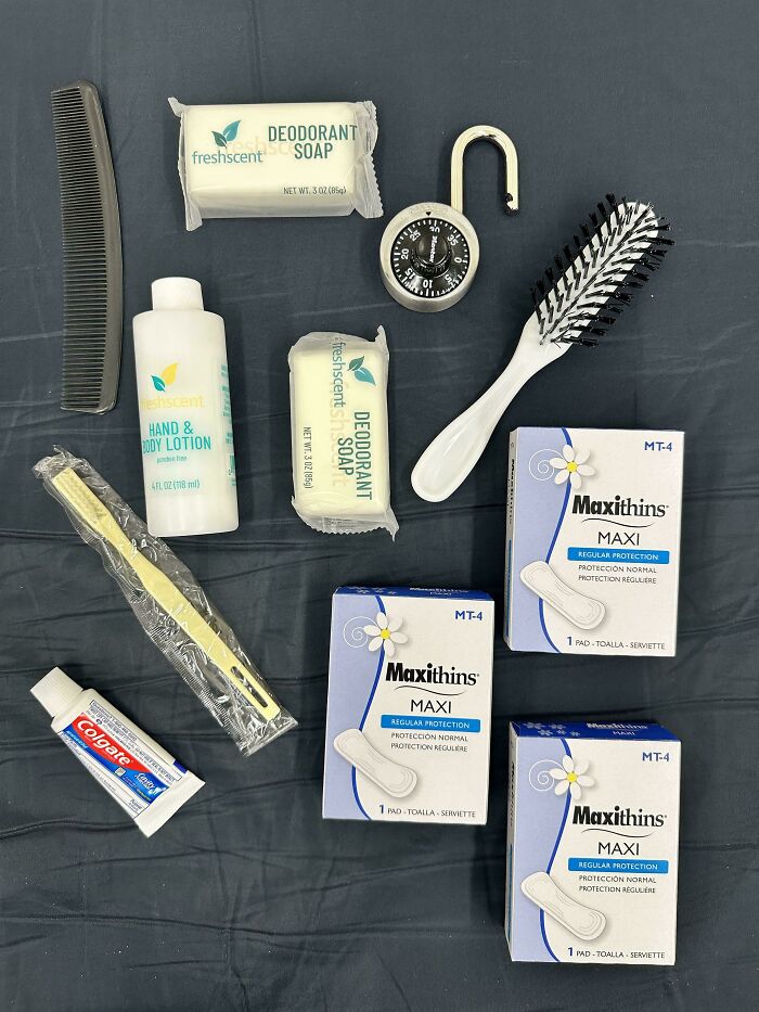 Toiletries and personal care items neatly arranged on a dark surface, illustrating satisfying order and organization.