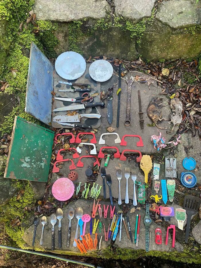 Neatly arranged tools, utensils, and various small objects on stone surface showcasing satisfying order and organization.