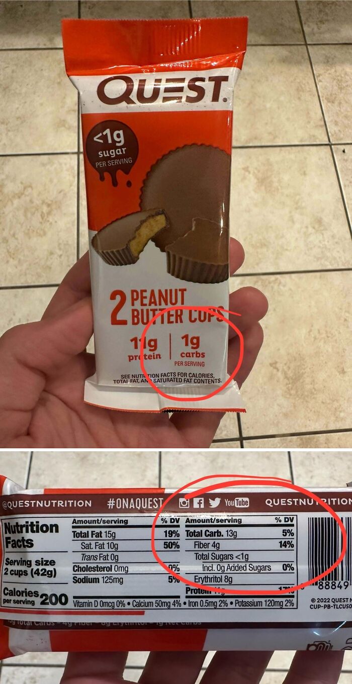 Hand holding Quest peanut butter cups with misleading packaging showing different carb amounts on front and nutrition facts.