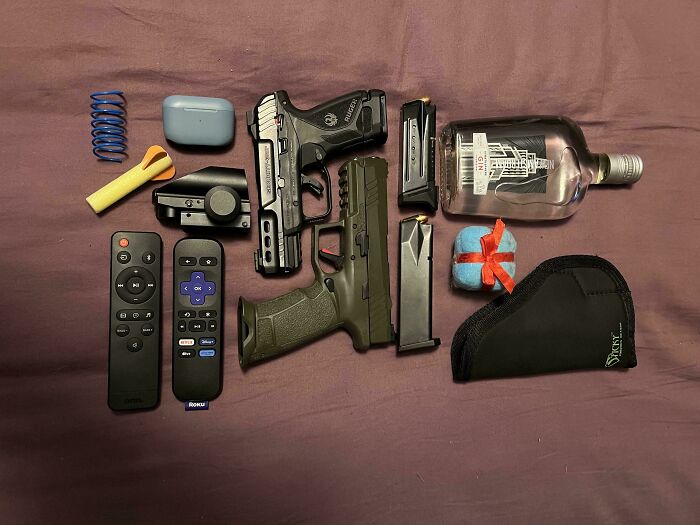Various household items, including guns, remotes, and accessories, neatly arranged to satisfy the need for order.