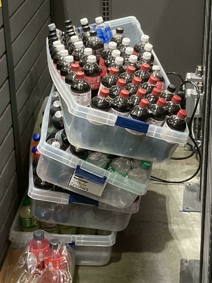 Stack of plastic bins filled with soda bottles representing frozen frames capturing moments without showing the aftermath.