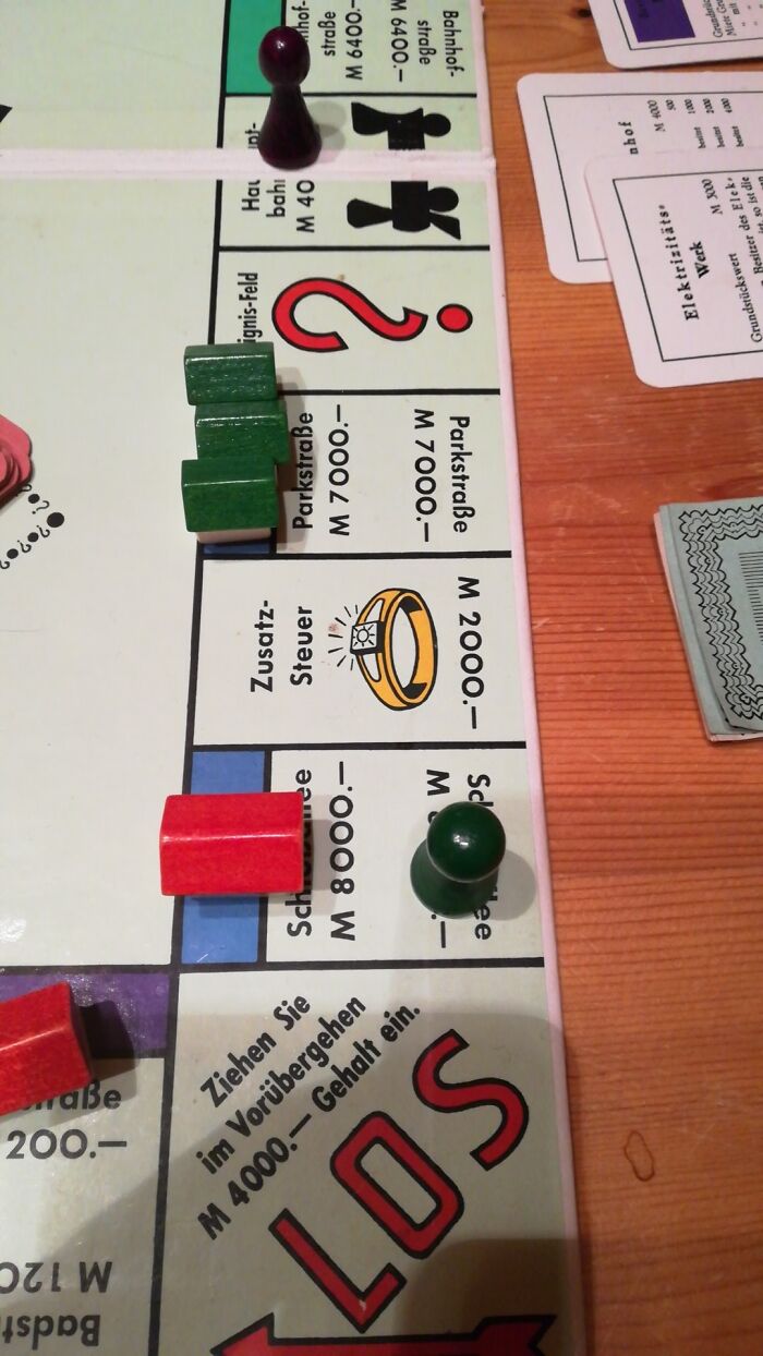 Close-up of a board game with game pieces on spaces showing frozen frames capturing game play moments.