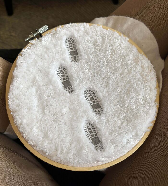Embroidery project showing detailed footsteps in fluffy white fabric, showcasing creative people and their cool projects.