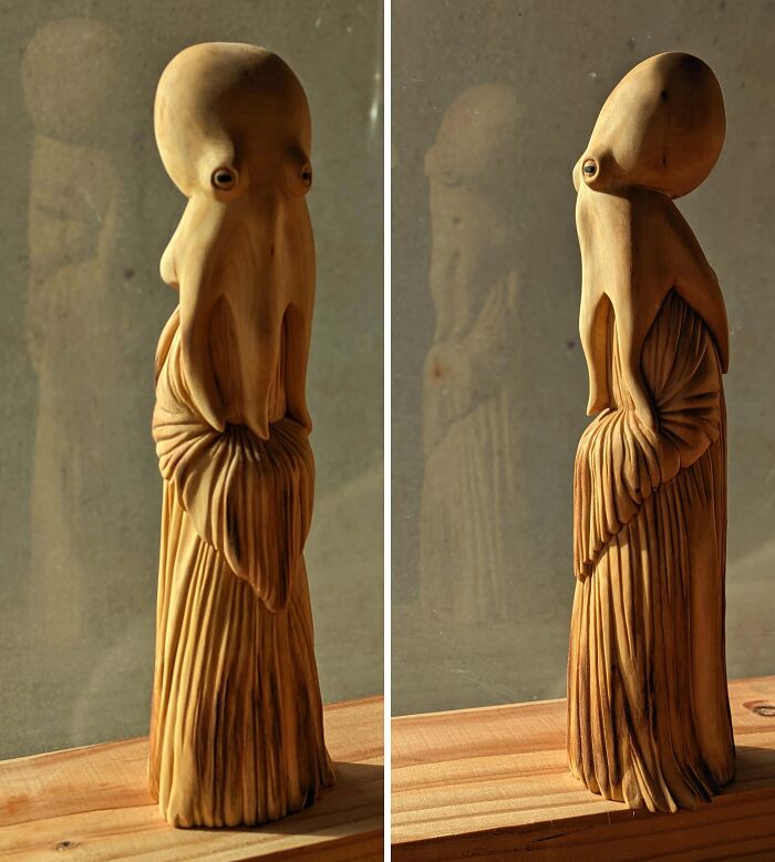 Wooden sculpture of a creative project featuring a surreal humanoid figure with detailed textures, showcasing unique craftsmanship.