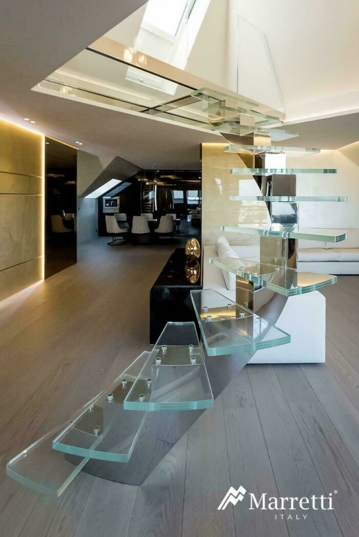 Modern glass stairs in luxury Airbnb interior highlighting Airbnb stairs insurance risks and safety concerns.