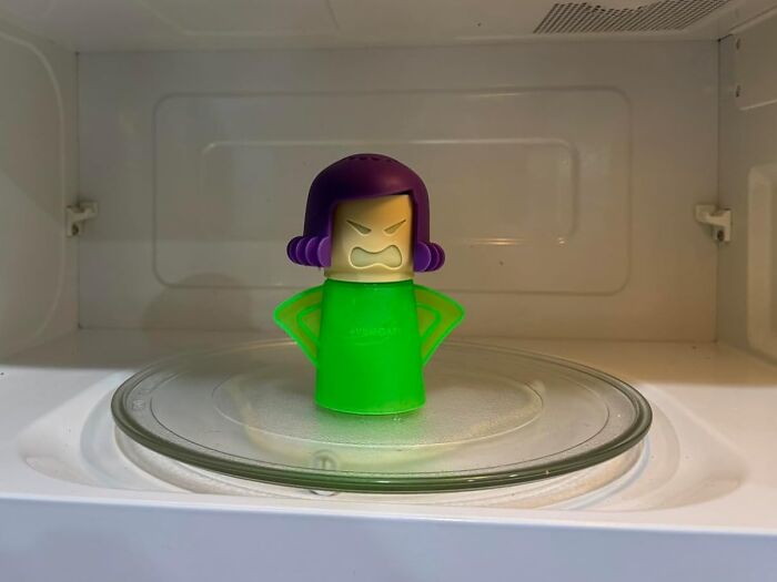 Angry purple-haired novelty figure in a microwave, a completely unnecessary novelty find for fun kitchen use.
