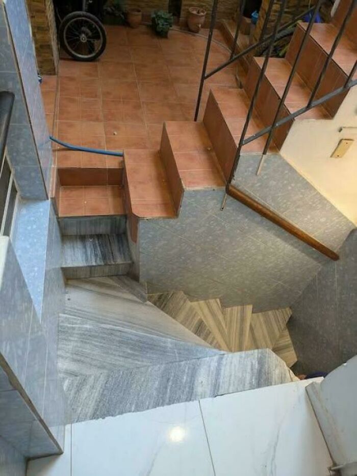 Confusing multi-level stairs inside a house with various tile patterns, illustrating Airbnb stairs risk and insurance needs.