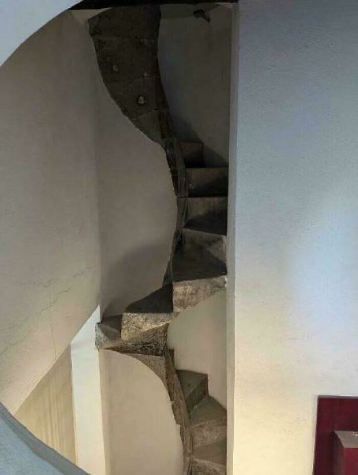 Narrow spiral staircase inside a building, illustrating a challenge related to Airbnb insurance and stairs safety.