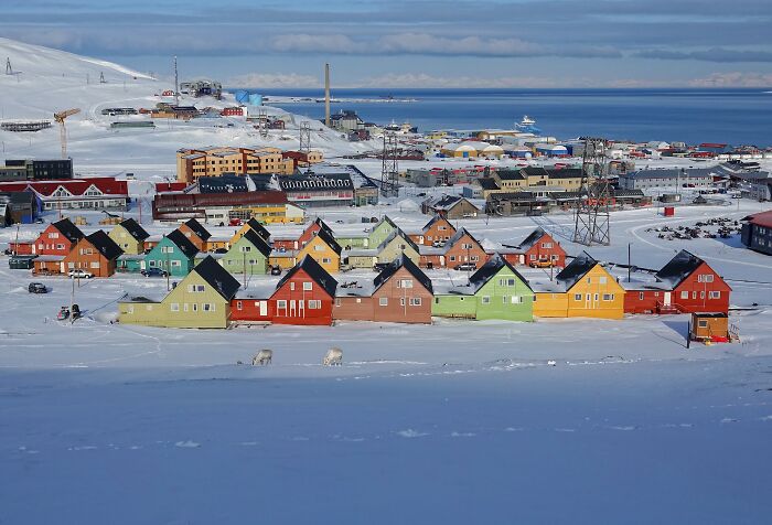 Colorful houses in a snowy remote location near the sea, showcasing one of the mind-blowing remote locations that actually exist