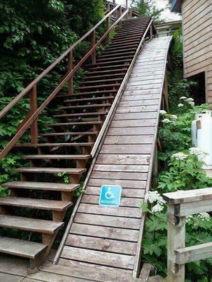 Steep wooden stairs and slippery accessible ramp beside a house surrounded by greenery, highlighting Airbnb insurance risks.
