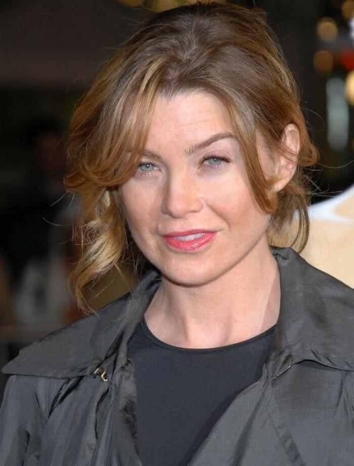 Ellen Pompeo close-up portrait with light brown hair, wearing a dark jacket at a public event indoors.